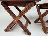 two wooden chairs that are sitting next to each other