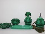 a green bathroom set with a broom and soap dispenser
