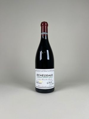 une bouteille de vin rouge posée sur une table blanche