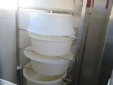 a tall stack of plastic containers in a kitchen