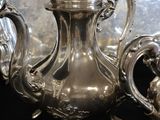 a silver tea pot sitting on top of a table