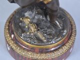 a statue of a man riding a horse on top of a table