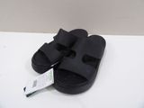 the black sandals are on a white surface with a price tag