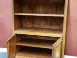 an image of a wooden cabinet with open doors in a room