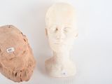 two clay heads sitting next to each other on a table