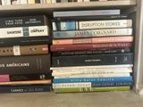 many books that are stacked on a bookshelf