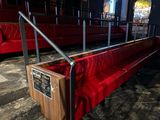 a red bench with a sign on it in the middle of a room