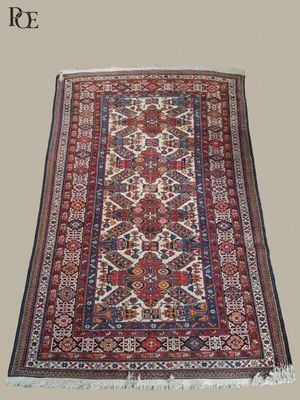 a red and blue rug with a pattern on it