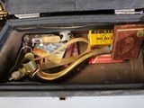 a black case with a pair of scissors and other items in it