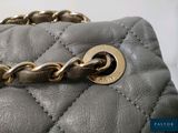 a close up of a purse with a chain on it