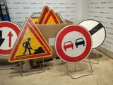 many different road signs that are on display in a room