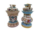 two vases sitting side by side on a white surface