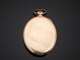 an antique pocket watch on a black surface with a black background