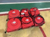 four red fire hydrants sitting on a cart on the floor