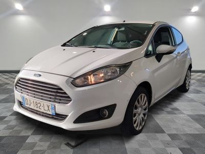 the white ford fiesta is parked in a room with a checkered floor