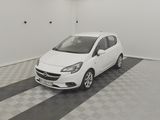 the small white car is parked in the empty room