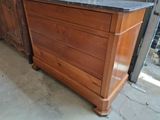 a wooden dresser with a granite top in a room