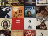 many different album covers on the wall of this room