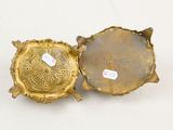 pair of gold plated candlestick holders with ornate designs