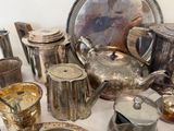 a table with a lot of silver items on it