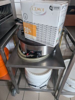a metal table with a basket on top of it in a kitchen