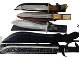 several different types of knives are lined up on a white surface