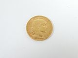 a close up of a gold coin on a white surface