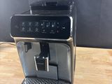 a black coffee machine sitting on top of a wooden table