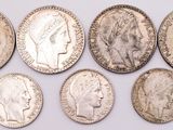 six different types of silver coins are shown on a white surface