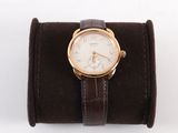 wrist watch with brown leather band and white dial on a white background