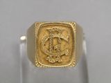 a close up of a gold ring with a lion on it