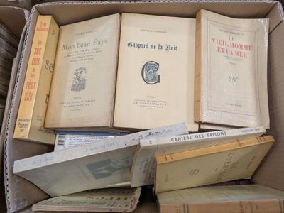 a box full of old books sitting on the floor