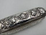 a silver box with a design on it on a table