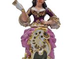 an image of a figurine of a woman sitting on top of a horse