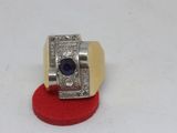 an image of a ring with a blue stone