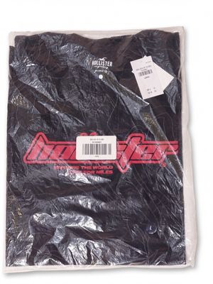 a close up of a black shirt with a red logo on it