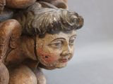 a close up of a figurine of a child with a bird on his head