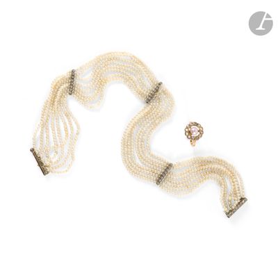 a close up of a necklace and a bracelet on a white surface