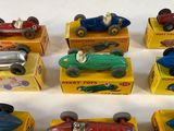 several toy cars are lined up in a row on a white surface