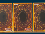 three cards that are sitting on top of each other