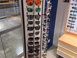 a display of sunglasses in a store with a lot of them
