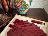 two vases on a table with a red leaf on it