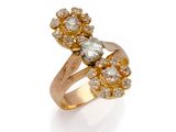a close up of a gold ring with diamonds on a white background