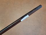 a close up of a wooden stick with a tag on it