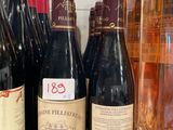 several bottles of wine are lined up on a counter
