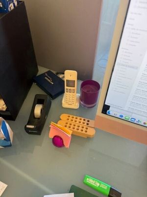 un bureau sur lequel se trouvent un ordinateur, un téléphone portable et d'autres objets