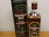 the bottle of bushmills malt is next to a canister
