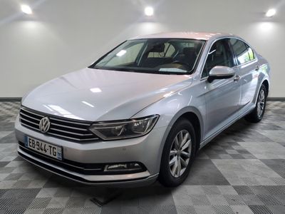 La Volkswagen Passat est garée dans une grande pièce au sol carrelé en damier.