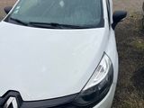 a white car parked in a parking lot next to other cars