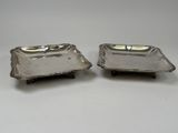 a pair of silver plated dishes on stands